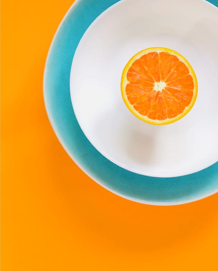 Sliced orange in colorful background